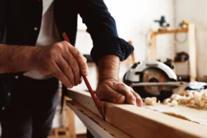 carpenter-makes-pencil-marks-wood-plank